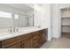 Bright bathroom boasts dual sinks and a glass-enclosed shower with modern finishes at 6653 Bridlespur St, Castle Pines, CO 80108