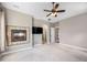 Spacious carpeted bedroom with fireplace, TV, and ceiling fan at 10127 Bluffmont Ln, Lone Tree, CO 80124