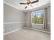 Bedroom featuring neutral walls and carpet, with a ceiling fan and large window at 10127 Bluffmont Ln, Lone Tree, CO 80124