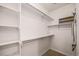 Walk-in closet with built-in shelving and ample storage space at 10127 Bluffmont Ln, Lone Tree, CO 80124