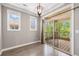 Bright dining area featuring a modern light fixture and balcony access at 10127 Bluffmont Ln, Lone Tree, CO 80124
