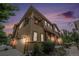 Inviting two-story townhome features a balcony, a garage, and mature landscaping at 10127 Bluffmont Ln, Lone Tree, CO 80124
