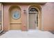 Inviting front entrance with a tan-colored door and arched window at 10127 Bluffmont Ln, Lone Tree, CO 80124