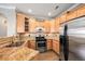 Well-equipped kitchen with stainless steel appliances and wood cabinets at 10127 Bluffmont Ln, Lone Tree, CO 80124