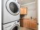 Convenient laundry room with modern washer and dryer, sink, and wooden cabinets at 10127 Bluffmont Ln, Lone Tree, CO 80124