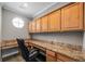Spacious office with granite countertops, wooden cabinets and a comfortable executive chair at 10127 Bluffmont Ln, Lone Tree, CO 80124