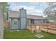 View of backyard featuring a well-maintained lawn, wooden deck, and neutral-tone exterior at 2026 S Pitkin St, Aurora, CO 80013