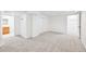 Open basement area with neutral paint, new carpeting, with an adjacent tiled bathroom at 2026 S Pitkin St, Aurora, CO 80013