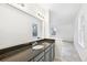 A bathroom with a gray granite countertop and a view into the bedroom at 2026 S Pitkin St, Aurora, CO 80013