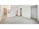 A bedroom with grey carpeting and large closets and bathroom nearby at 2026 S Pitkin St, Aurora, CO 80013