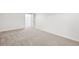 Cozy carpeted bedroom with neutral paint, baseboard trim, and an open closet at 2026 S Pitkin St, Aurora, CO 80013