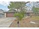 Charming single-Gathering home with front yard, mature trees, swing and brick and siding exterior at 2026 S Pitkin St, Aurora, CO 80013