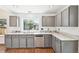 Functional kitchen offering granite countertops, grey cabinetry, and stainless steel appliances at 2026 S Pitkin St, Aurora, CO 80013