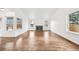 Living room featuring hardwood floors, a fireplace, and large windows at 2026 S Pitkin St, Aurora, CO 80013