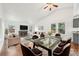 Open-concept living and dining space with a fireplace, hardwood floors and vaulted ceiling at 2026 S Pitkin St, Aurora, CO 80013