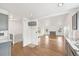 Open concept living space showcasing hardwood flooring, vaulted ceiling and updated finishes at 2026 S Pitkin St, Aurora, CO 80013