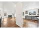 Open-concept living space with hardwood floors and view into kitchen and dining area at 2026 S Pitkin St, Aurora, CO 80013