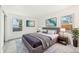 This is a staged bedroom with a large grey bed frame and two matching framed art pieces on the wall at 2026 S Pitkin St, Aurora, CO 80013