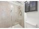 A tile shower with a glass door and mounted toiletry cabinet at 2026 S Pitkin St, Aurora, CO 80013