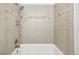 A tile shower with both a mounted and handheld shower head at 2026 S Pitkin St, Aurora, CO 80013
