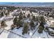 Gorgeous aerial view showcasing a home surrounded by snow-covered landscape with a wooden fence at 17870 New London Rd, Monument, CO 80132