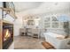 Spa-like bathroom with dual vanities, a soaking tub, and decorative fireplace at 17870 New London Rd, Monument, CO 80132