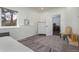 Bright bedroom features a soft carpet, a white dresser, and a window overlooking the outdoors at 17870 New London Rd, Monument, CO 80132