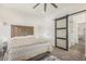 Comfortable bedroom featuring natural light, a sliding barn door to bath and a ceiling fan at 17870 New London Rd, Monument, CO 80132