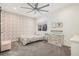 Bright bedroom featuring floral wallpaper and ceiling fan at 17870 New London Rd, Monument, CO 80132