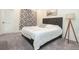 Contemporary bedroom features modern bed, plush carpet, stylish curtain, and unique tripod lamp at 17870 New London Rd, Monument, CO 80132