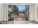 A view to the deck through sliding glass doors, perfect for entertaining and enjoying scenic outdoors at 17870 New London Rd, Monument, CO 80132