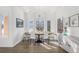 Bright dining room features a modern chandelier, large windows and wood flooring at 17870 New London Rd, Monument, CO 80132