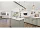 Spacious open kitchen with breakfast bar, modern lighting and ample counter space at 17870 New London Rd, Monument, CO 80132