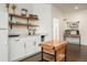 Bright kitchenette with open shelving, white cabinets, and a butcher block island for food preparation at 17870 New London Rd, Monument, CO 80132