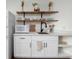 Well-lit kitchenette features open shelves, white cabinets, and modern appliances for convenient meal preparation at 17870 New London Rd, Monument, CO 80132