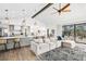 Open-concept living space with vaulted ceilings, modern furnishings, and sliding door access to deck at 17870 New London Rd, Monument, CO 80132