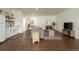 Open living room features wood floors, a gray sofa, and contemporary decor, creating a welcoming space at 17870 New London Rd, Monument, CO 80132