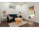 Cozy living room features a blue sofa, round table, and natural light from the window and glass door at 17870 New London Rd, Monument, CO 80132