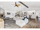Spacious living room boasts a ceiling fan, fireplace and hardwood floors at 17870 New London Rd, Monument, CO 80132