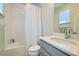 Bright bathroom with a tub and shower, neutral tones, and modern sink at 2052 Alcott Way, Broomfield, CO 80023