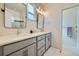 Double vanity bathroom with gray cabinets, modern mirrors, and bright lighting at 2052 Alcott Way, Broomfield, CO 80023