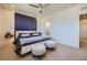 Modern bedroom featuring a blue accent wall, neutral carpet, and ensuite bathroom for convenience at 2052 Alcott Way, Broomfield, CO 80023