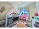 Playful bedroom featuring a loft bed, colorful rug, and dollhouse, creating a whimsical space at 2052 Alcott Way, Broomfield, CO 80023
