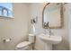 Well-lit half-bathroom with stylish pedestal sink, modern toilet, and decor at 2052 Alcott Way, Broomfield, CO 80023