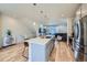 Open kitchen showcases stainless steel appliances, a large island, and hardwood floors at 2052 Alcott Way, Broomfield, CO 80023