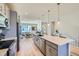 Open floor plan with kitchen island featuring seating and stainless steel appliances at 2052 Alcott Way, Broomfield, CO 80023