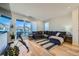 Bright living room boasts a large sliding glass door to a spacious outdoor balcony at 2052 Alcott Way, Broomfield, CO 80023