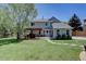 Large backyard with patio, pergola, and mature landscaping at 20113 Edinborough Ct, Parker, CO 80138