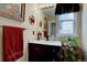 Charming bathroom features a vanity with marble countertop, decorative mirror, and natural light at 20113 Edinborough Ct, Parker, CO 80138