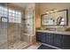 Bathroom with frameless glass shower, bench, neutral tile and glass vessel sink at 20113 Edinborough Ct, Parker, CO 80138